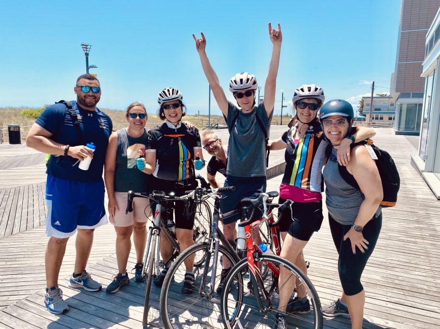 Landscape Adults celebrating bikeride on Boardwalk Cute